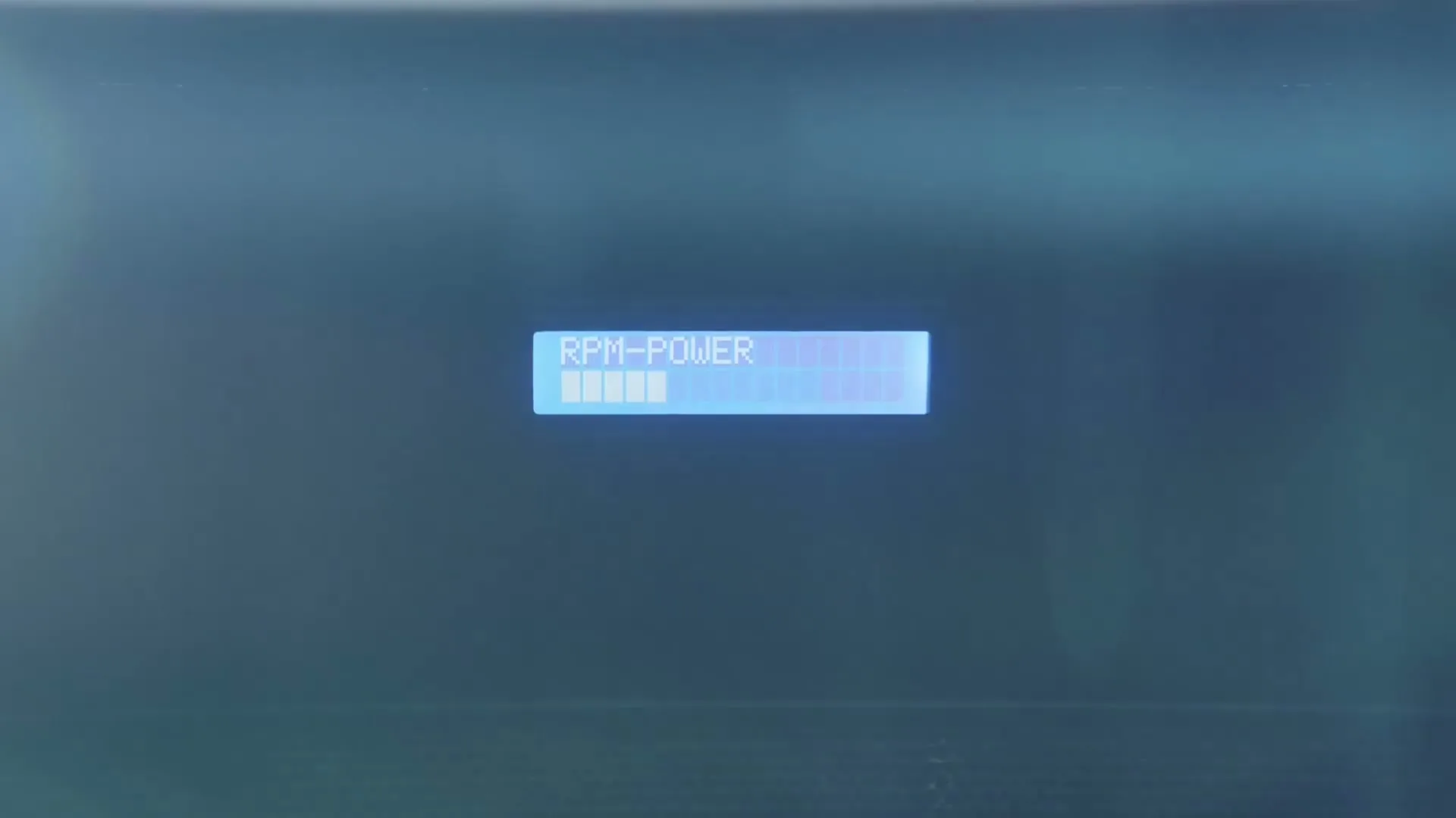A digital display shows "RPM-POWER" with a loading bar, indicating increasing power in a vehicle.