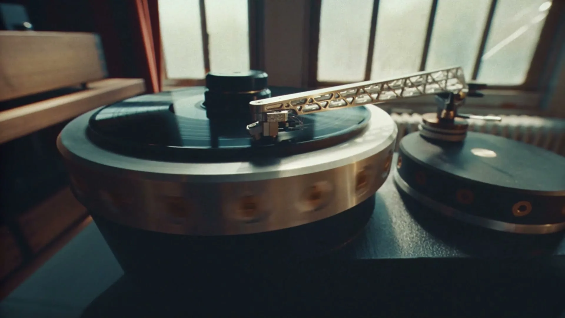 A close-up shot of a vintage record player with a spinning vinyl record, bathed in natural light from a window.