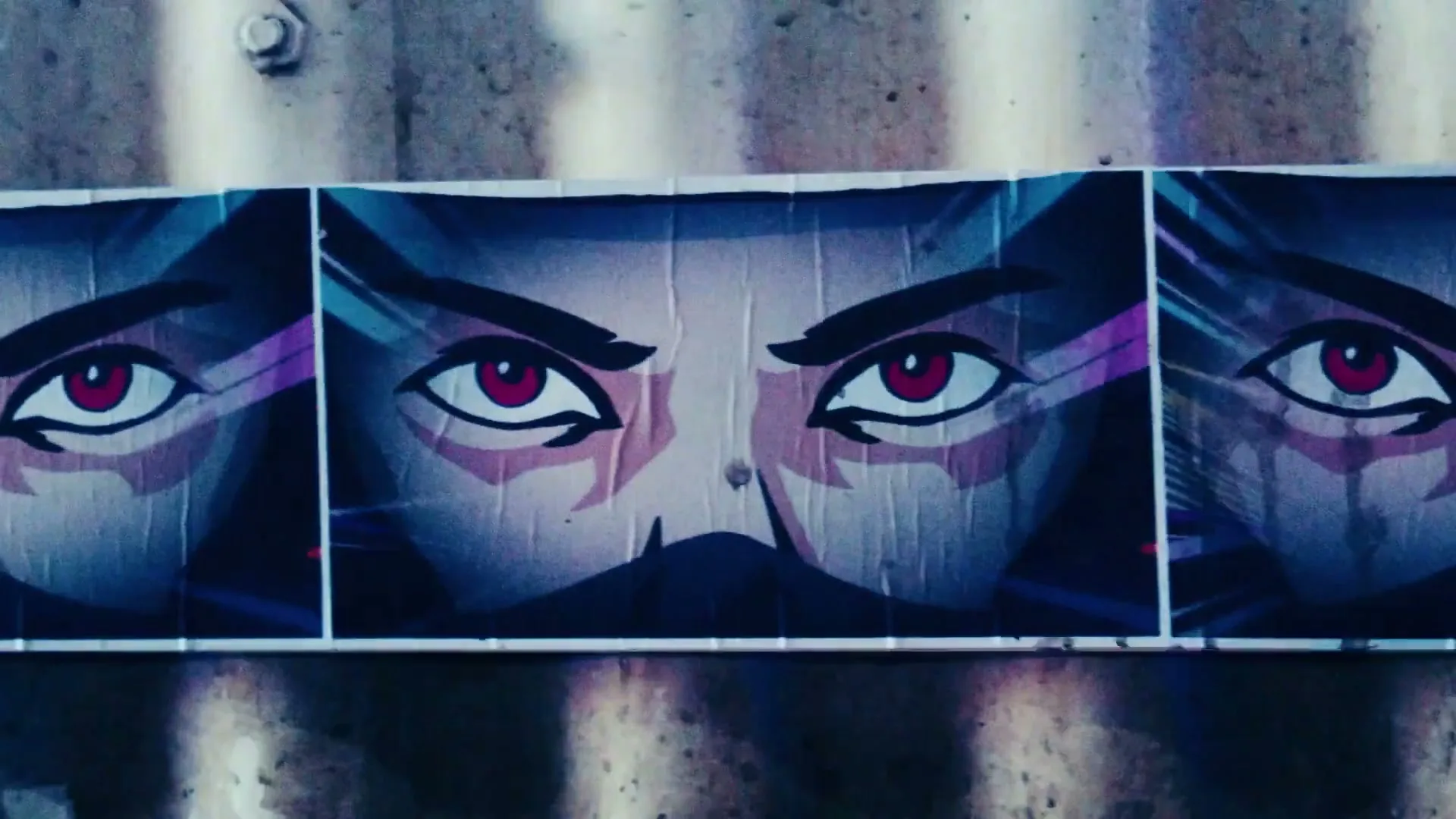 A close-up shot of a wall with three animated posters of a person's eyes, which then transform into a helmet, then into a white shape.
