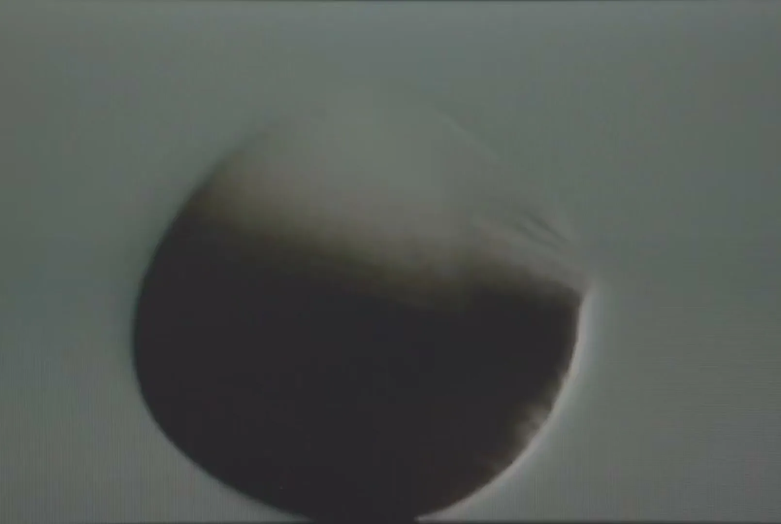 A blurry, dark object, possibly a football, spins rapidly against a light background, creating a dynamic, abstract visual.
