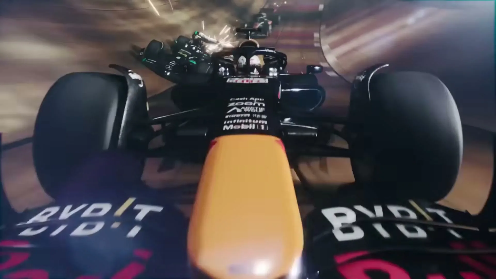 A Formula 1 race car speeds around a track at night, with sparks flying from other cars in the background.