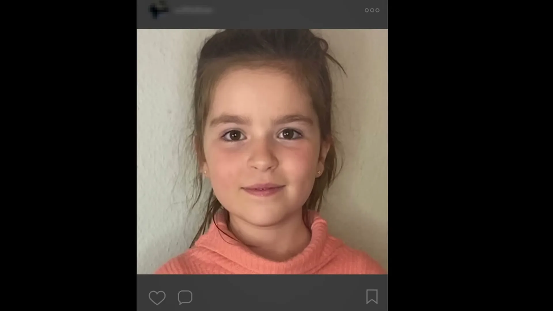 A young girl with brown hair and a pink top smiles at the camera, her image displayed within a social media interface on a computer screen.