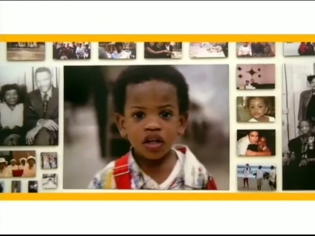 A young Black boy with curly hair and colorful overalls looks directly at the camera, surrounded by a collage of diverse family photographs.