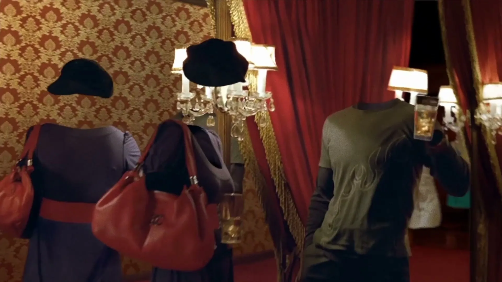 Three invisible people, two women in dresses and a man in a t-shirt, stand in a lavish room with red curtains and patterned wallpaper, holding drinks.