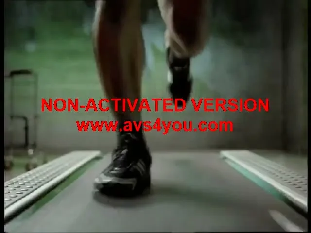 A male athlete's muscular legs and feet run on a treadmill in a gym, showcasing intense physical exertion.