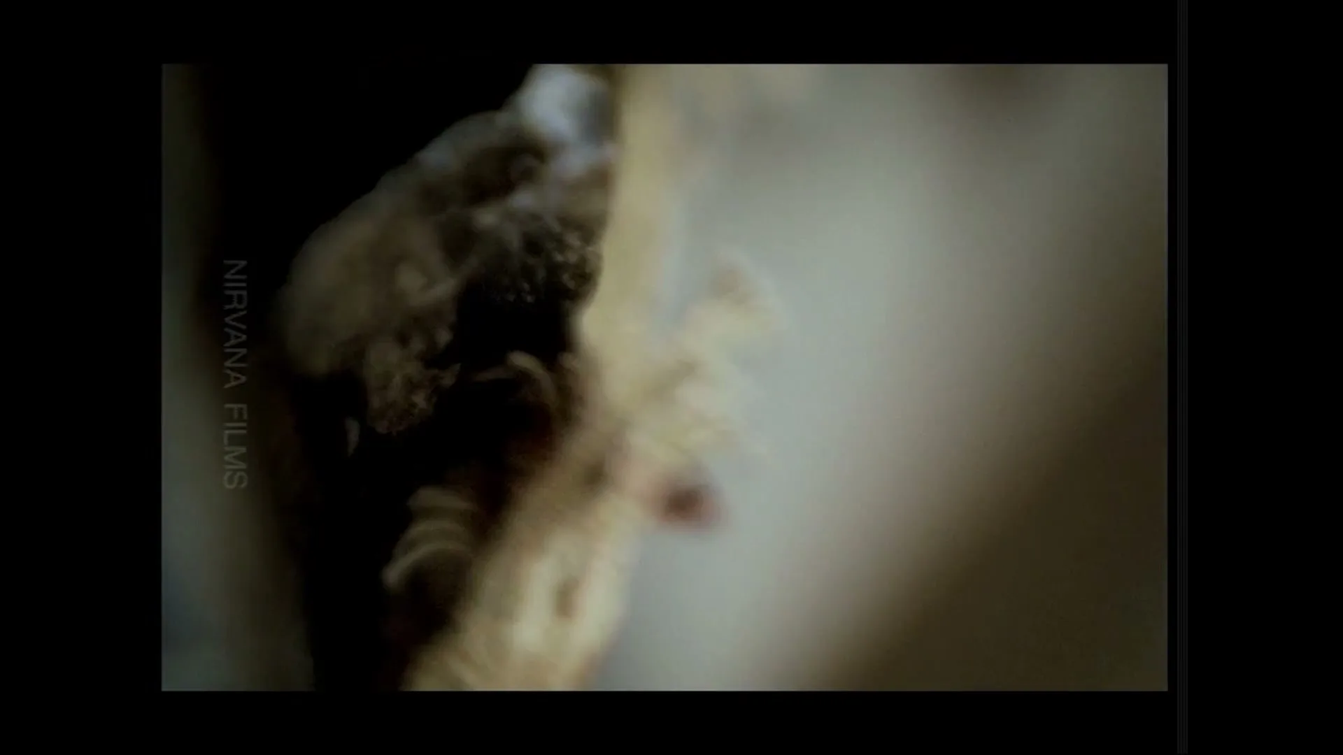 A macro shot shows a rusty nail being pulled out of a wooden surface, revealing splinters and debris.