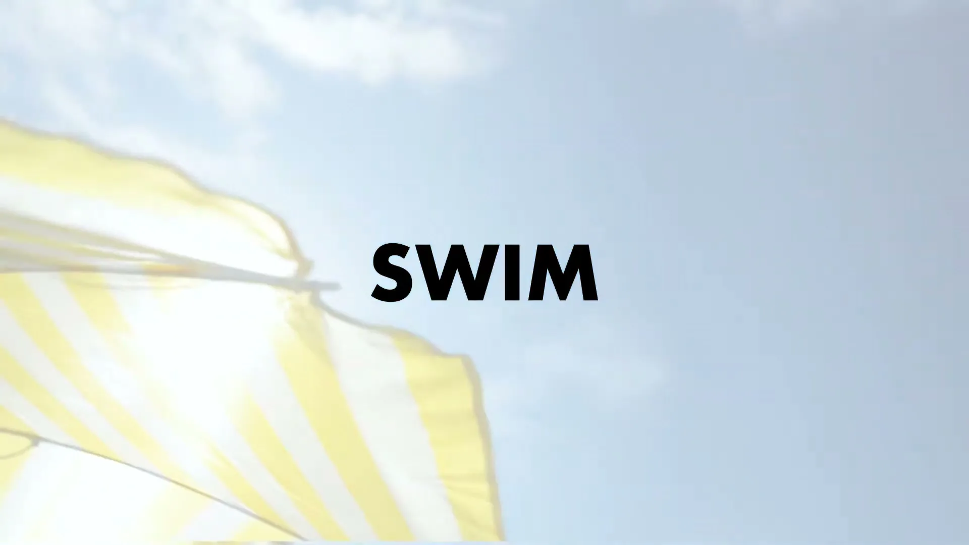 The word "SWIM" is displayed in black text against a bright blue sky with a yellow and white striped beach umbrella in the bottom left corner.