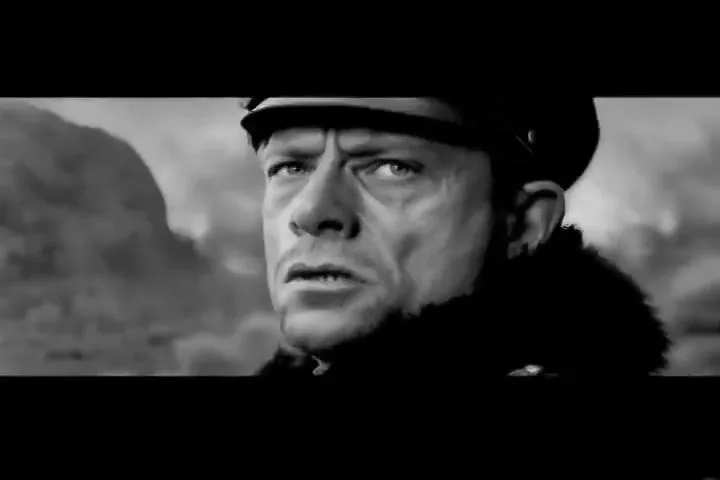 A man in a pilot's uniform looks out of a window, then turns to face the camera with a concerned expression, in a black and white shot.