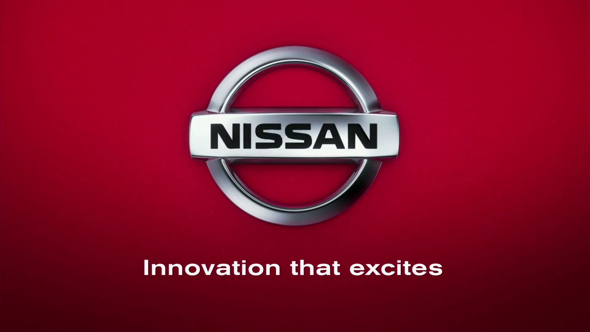 The Nissan logo, a silver emblem with the word "NISSAN" in black, is centered on a vibrant red background, with a tagline below.