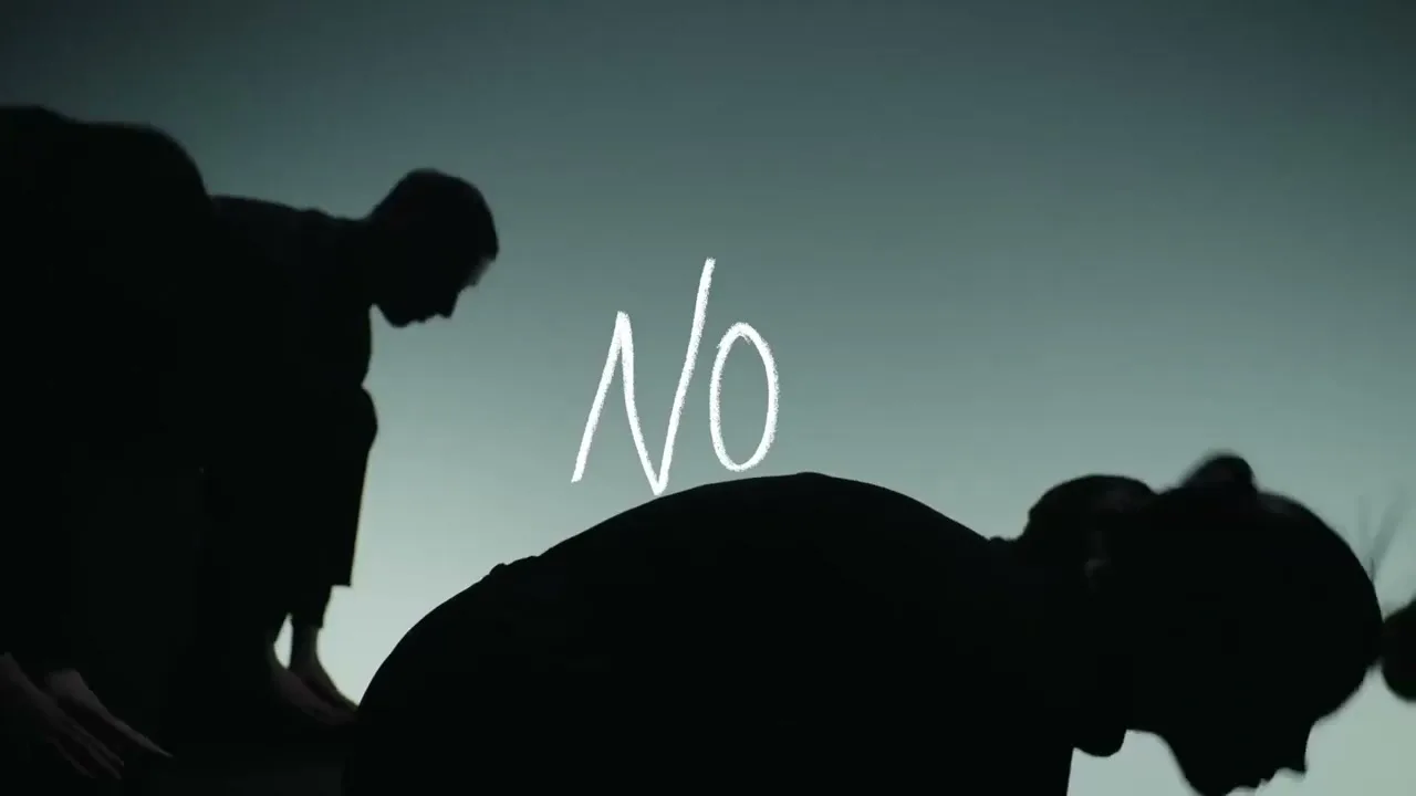 Silhouetted figures are seen from a low angle, with the word "No" appearing in white text against a dark background.