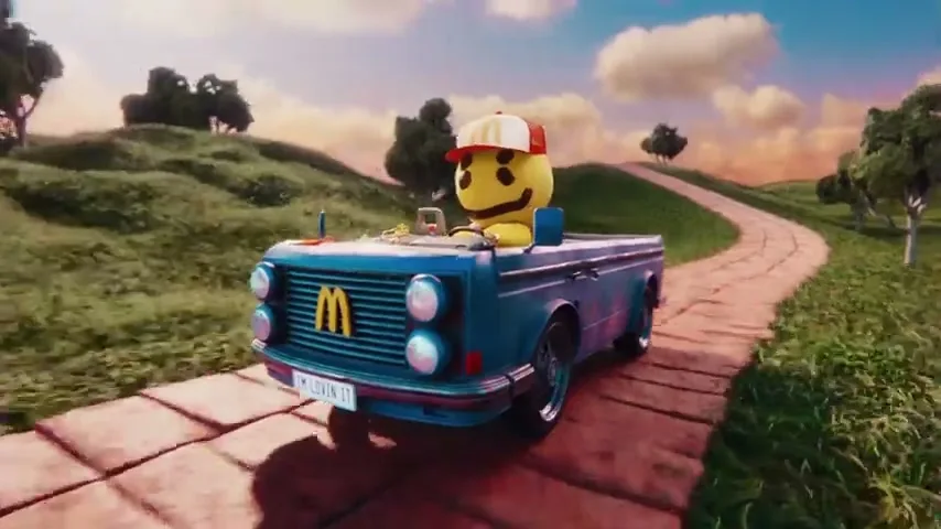 A yellow, round, smiling character wearing a red and white McDonald's hat drives a blue car with a McDonald's logo on the grill down a winding path in a stylized, hilly landscape.