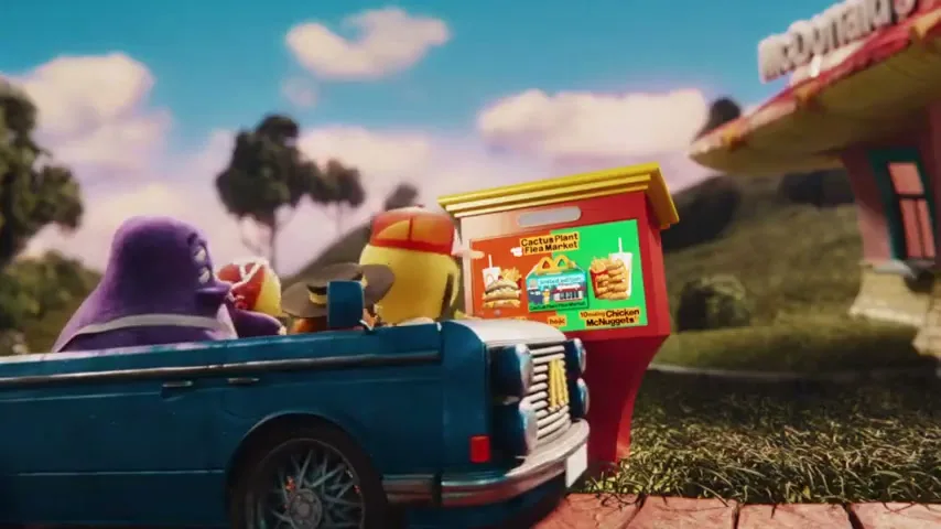 A blue car with three animated characters, including Grimace, drives past a McDonald's drive-thru menu board on a sunny day.
