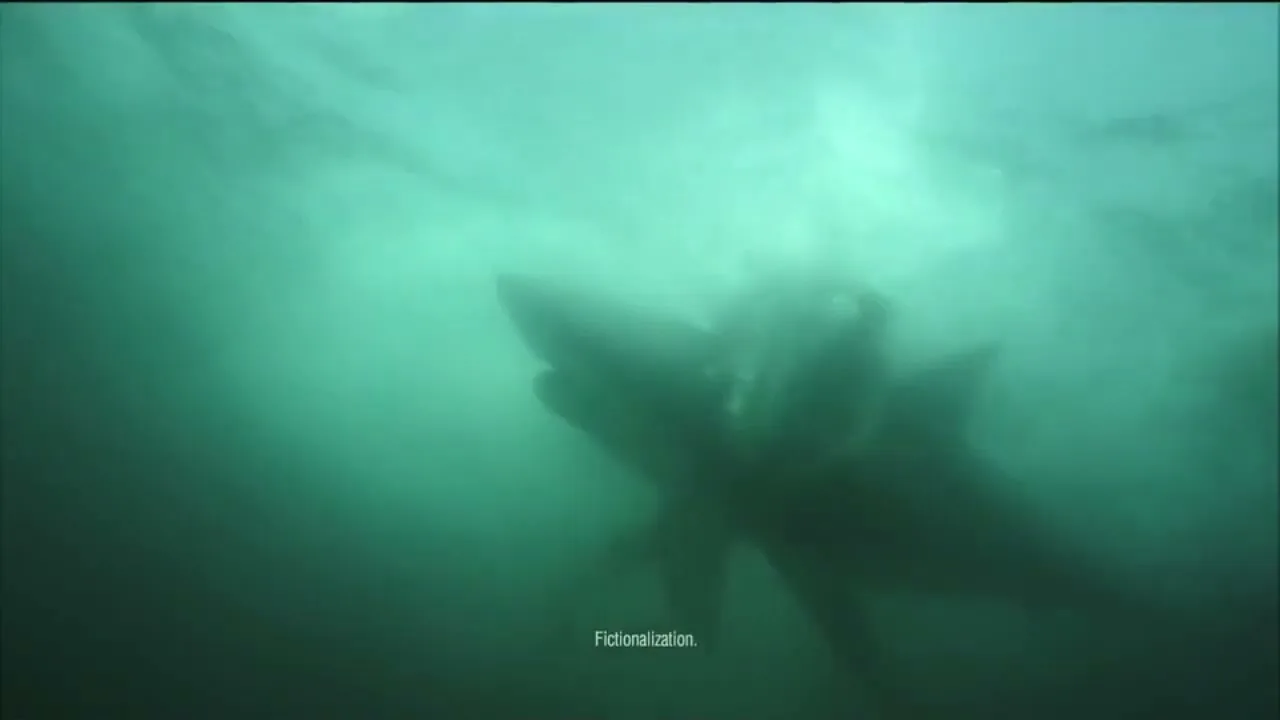 A large, dark shark-like creature swims underwater in murky green water, with light filtering from the surface above.