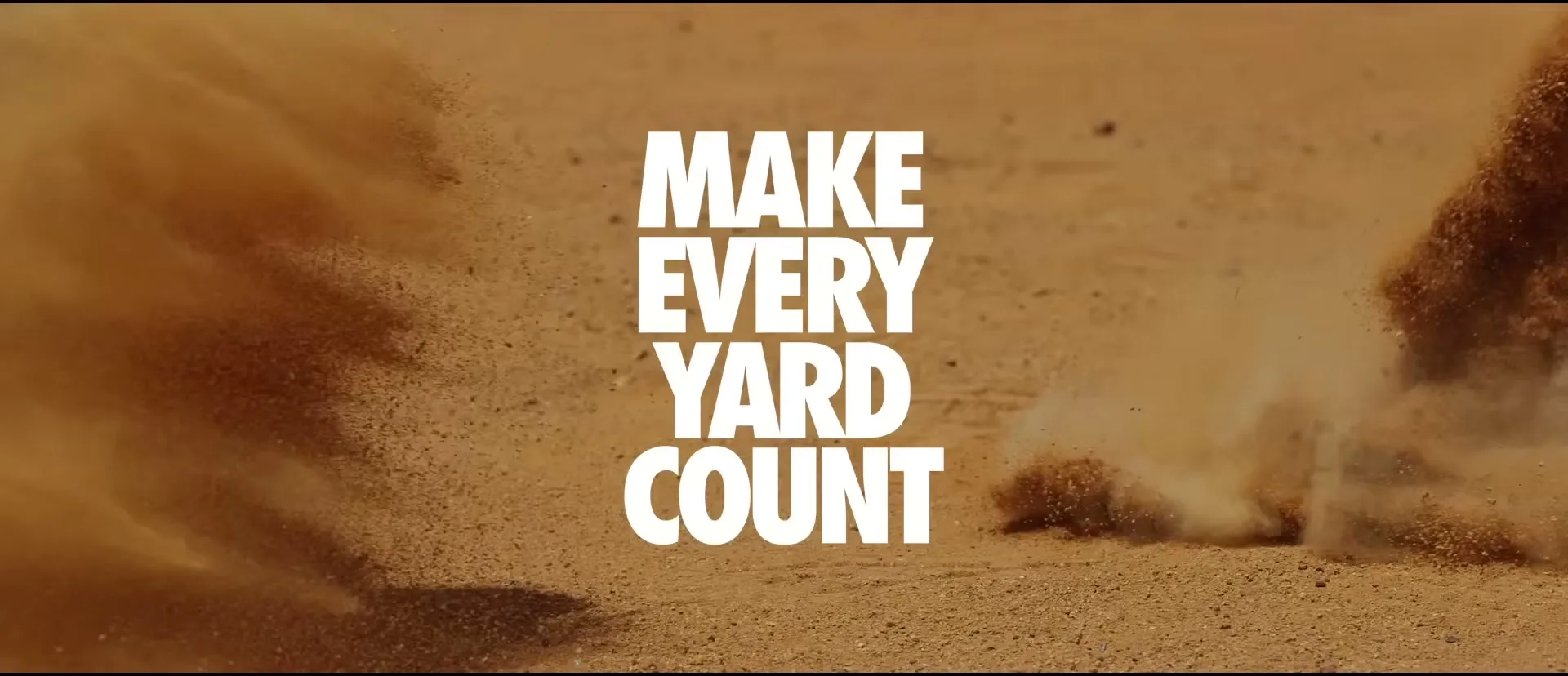 White text "MAKE EVERY YARD COUNT" appears on screen as dirt and sand explode outwards from the center of the frame in a desert.