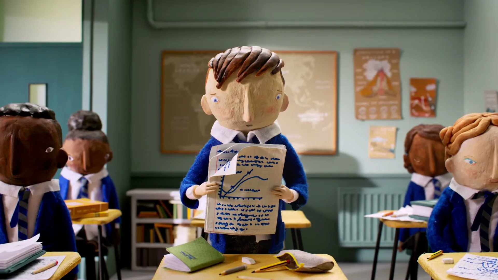 A stop-motion animated boy in a school uniform holds up a paper with a graph, then his body distorts and papers fly around him in a classroom.
