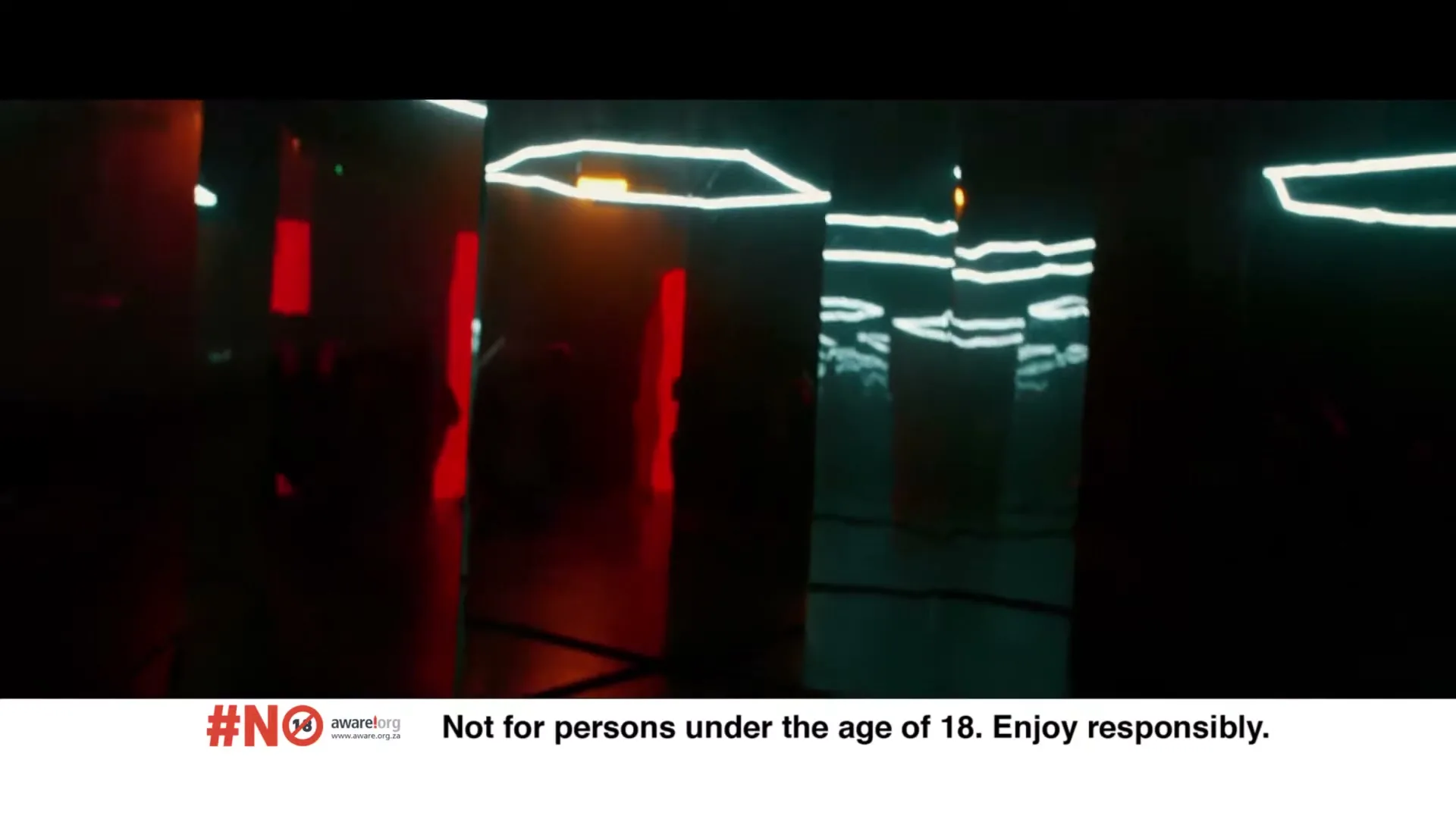 A dark, abstract space with glowing neon lights in red and white, reflected in multiple mirrored surfaces, creating an infinite, disorienting effect.
