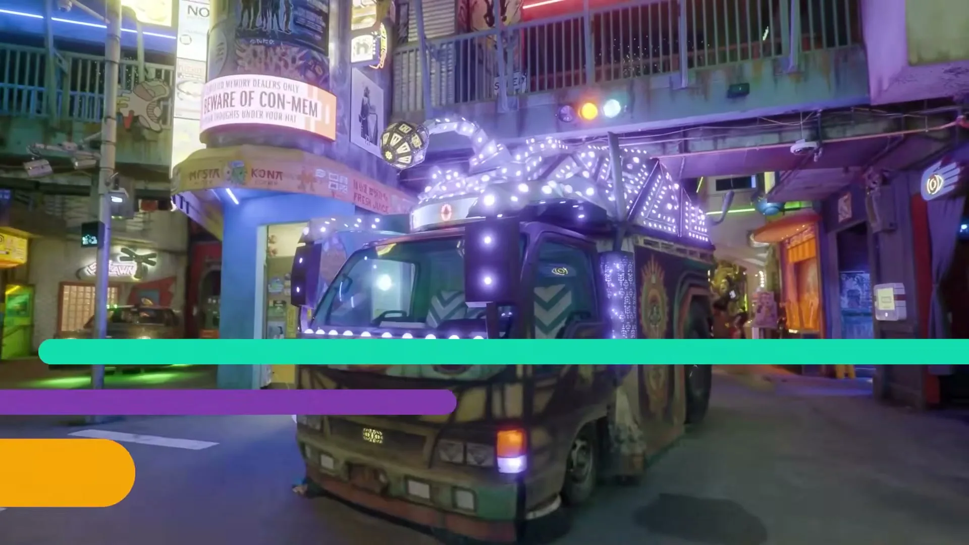 A colorful, highly decorated truck with many lights drives slowly through a vibrant, neon-lit street in an indoor art installation.
