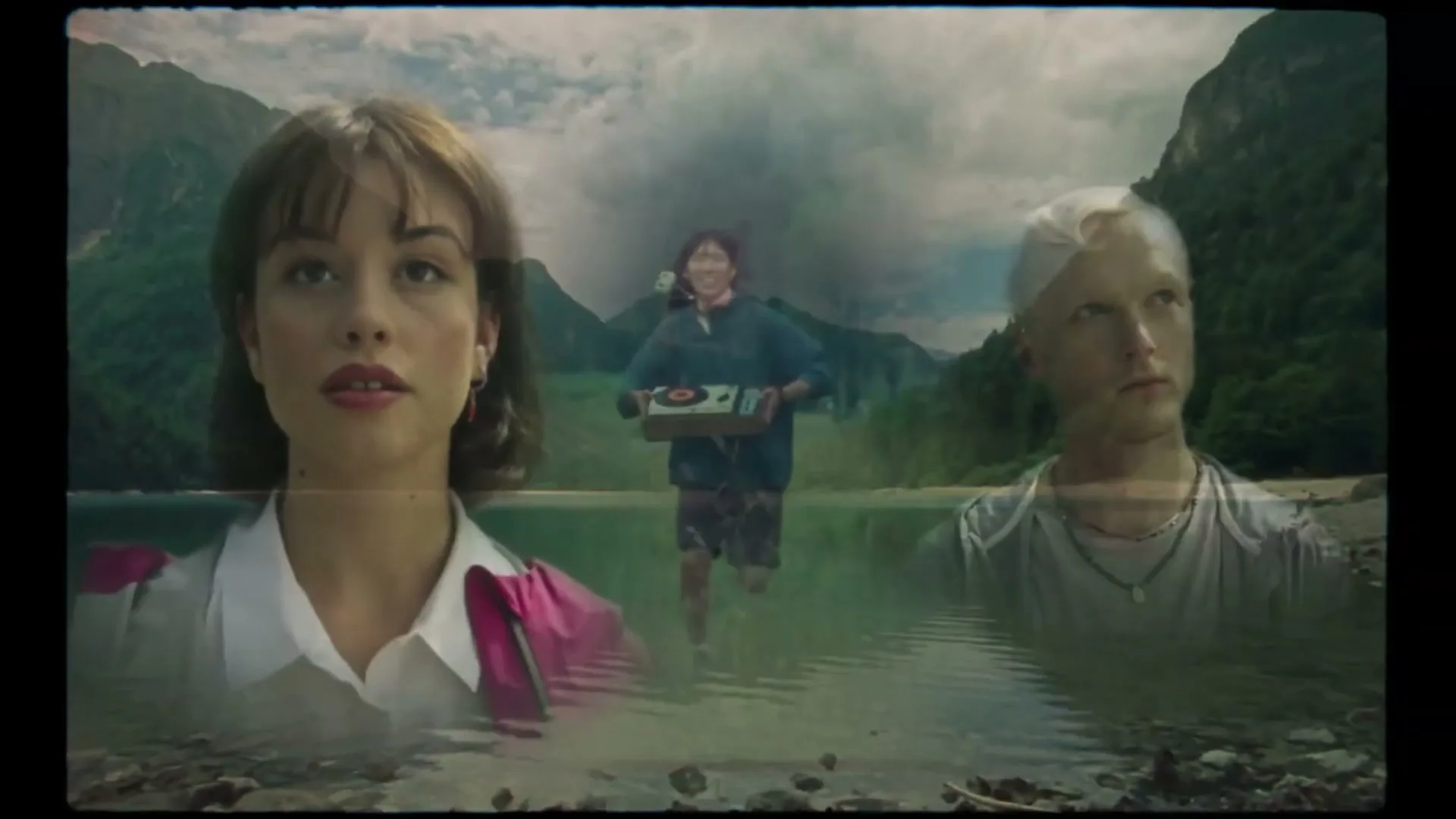 A composite shot shows a young woman and man in the foreground, with another person running through a lake in the background, surrounded by mountains.