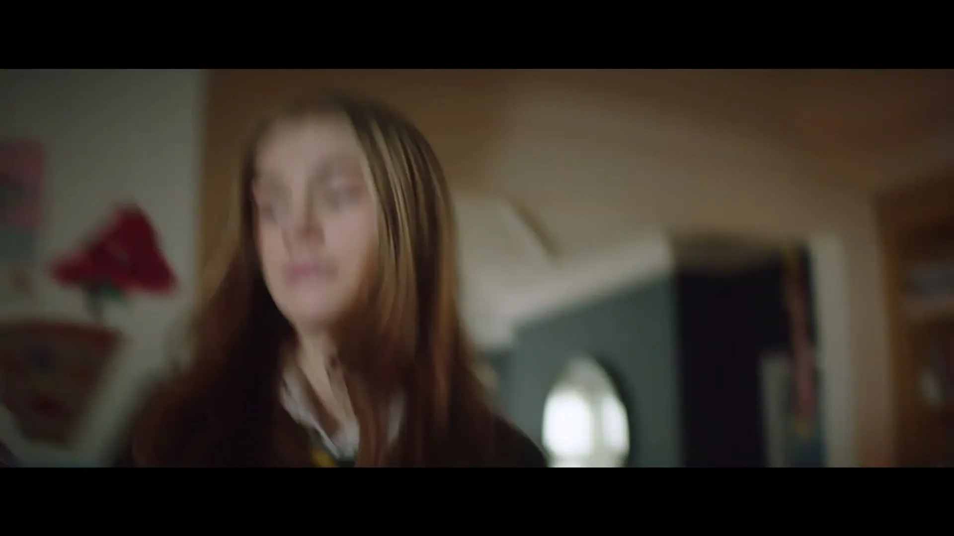 A father and his daughter are in a kitchen, the daughter is looking for something in a cupboard, then she walks away from the camera.