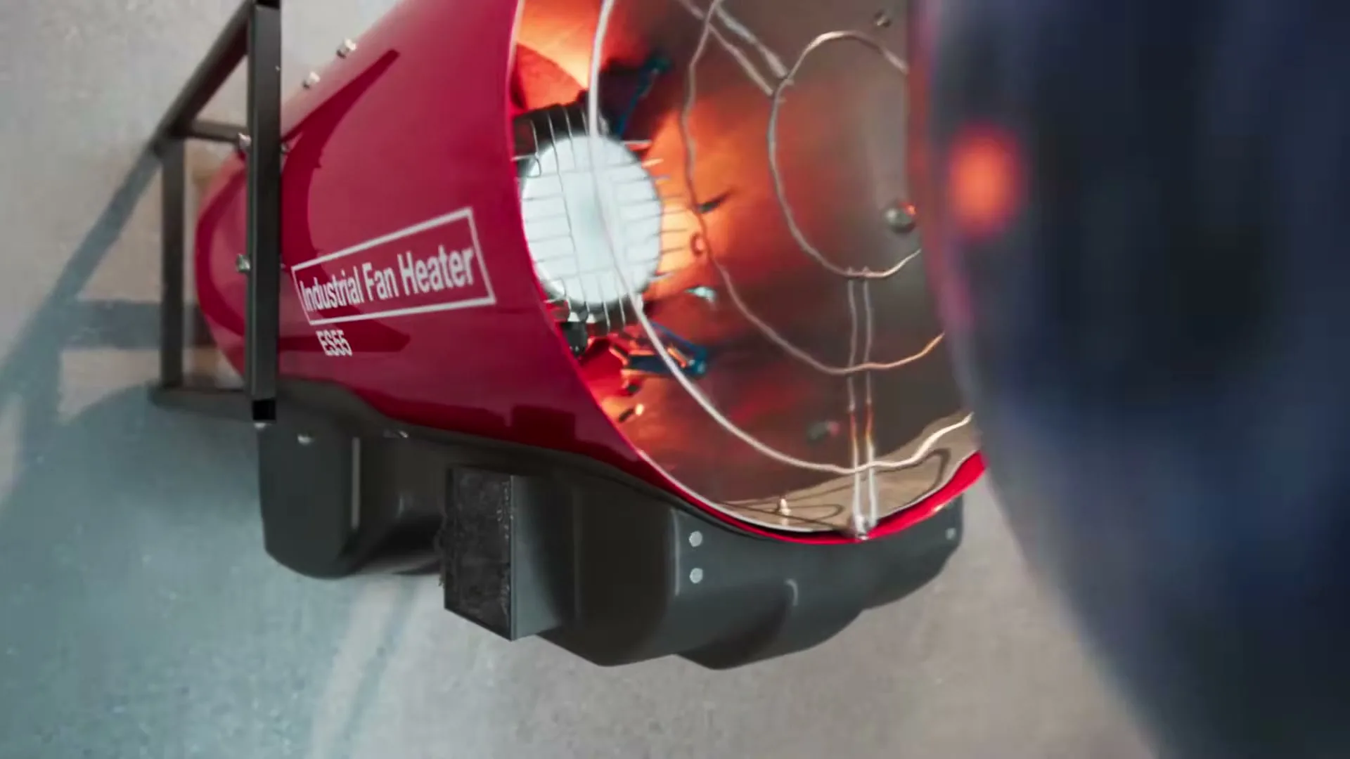 A person in a blue shirt and brown pants sits on the floor next to a glowing globe and a red industrial fan heater, which then reveals a fox in a dark, overgrown space.