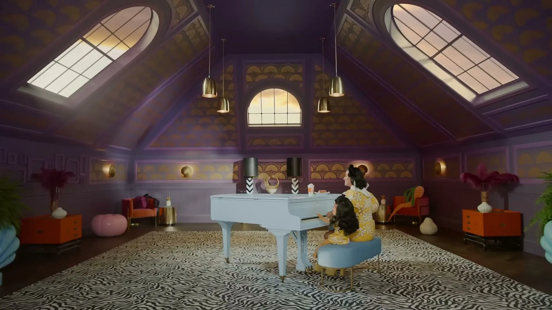 A woman and a young girl in matching yellow outfits sit at a white grand piano in a lavish purple and gold attic room.