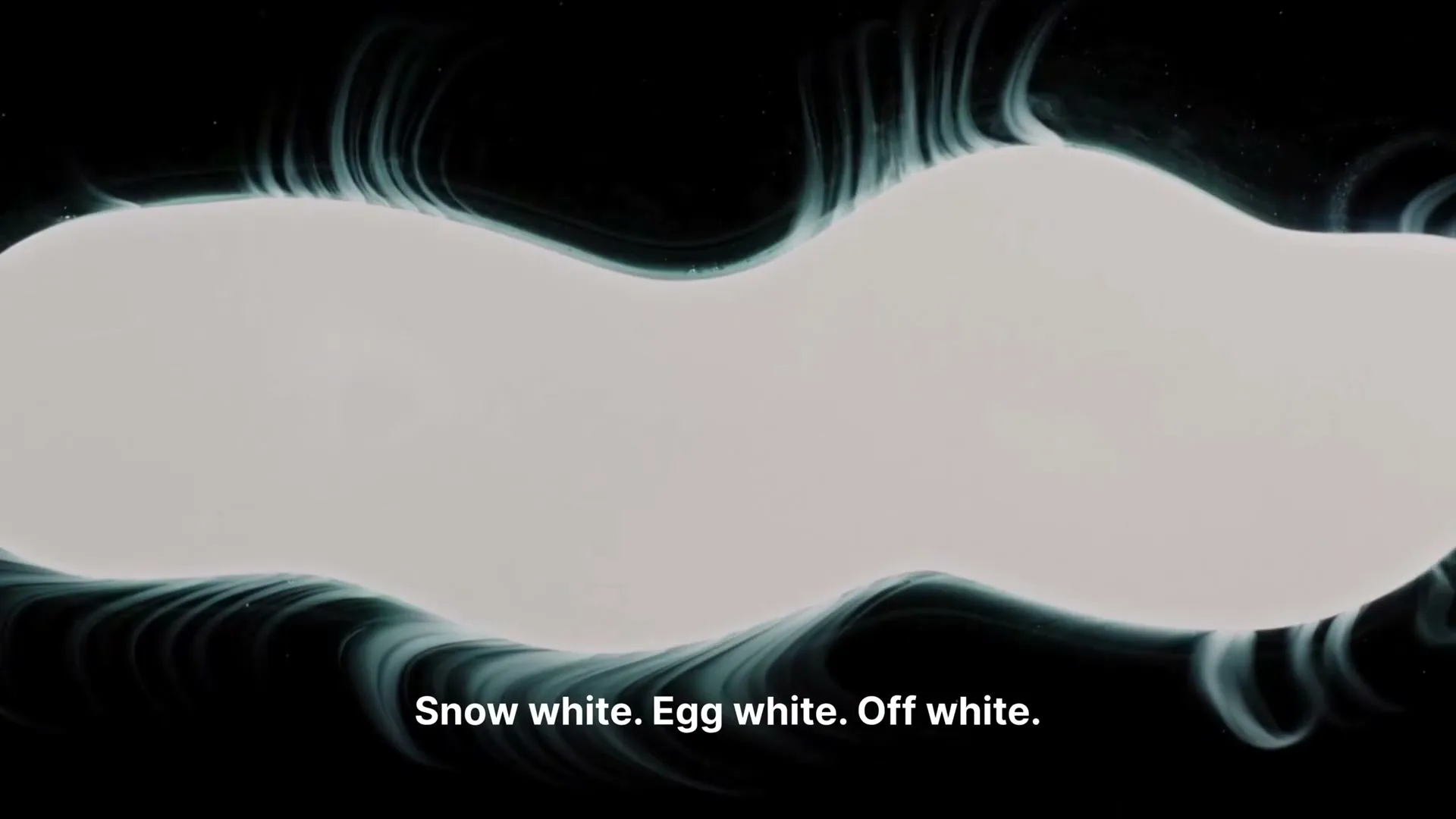 A white, amorphous shape with glowing blue edges floats against a black background, with text appearing at the bottom of the screen.