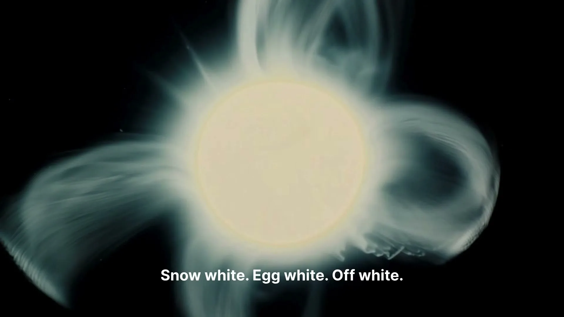 A bright, glowing white orb with wispy, smoke-like tendrils emanating from it, against a dark background.