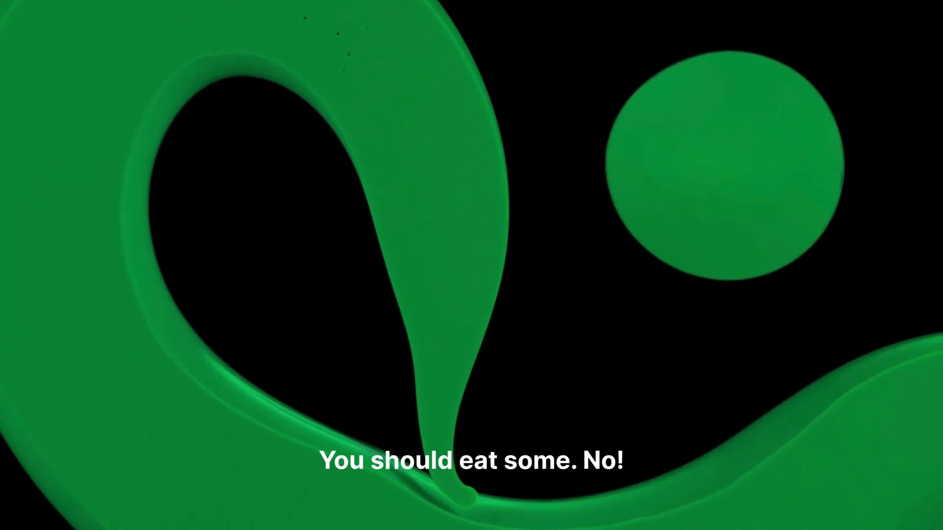 A vibrant green liquid paint flows and swirls against a black background, forming abstract shapes and a circular blob, with text appearing on screen.