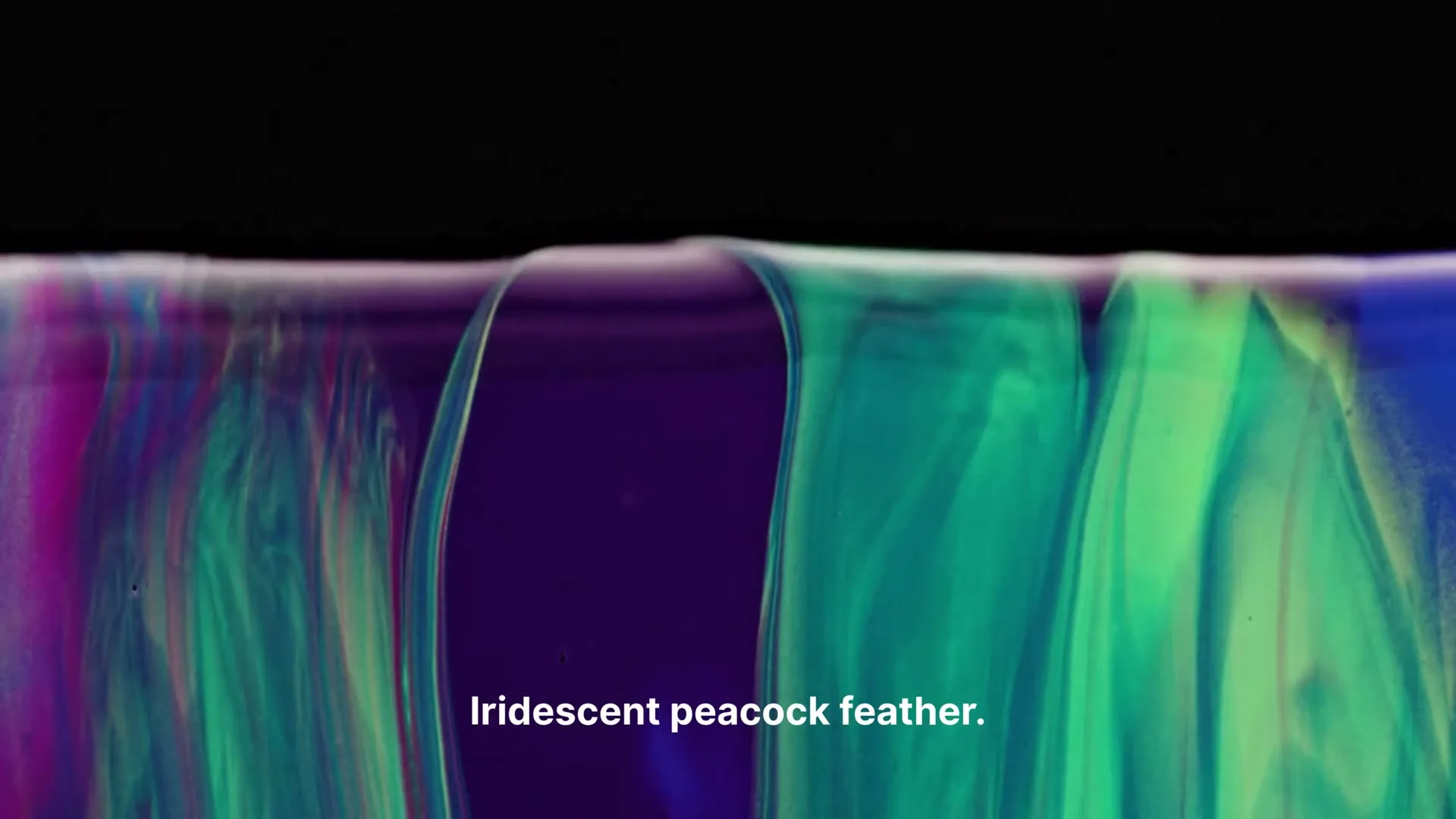 A macro shot shows iridescent green and purple liquid swirling and mixing against a dark background, with text appearing on screen.