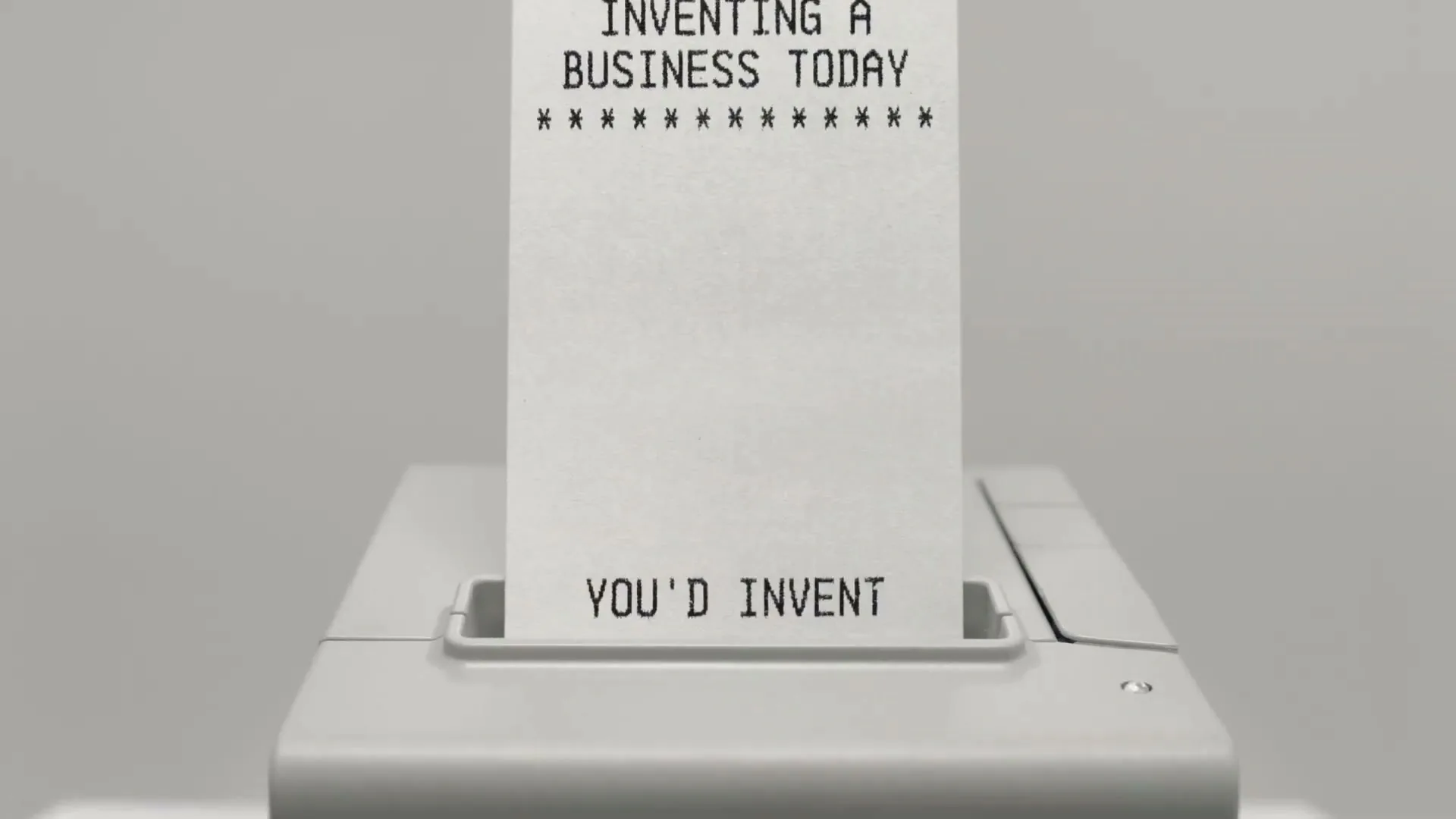 A receipt printer prints out text, then the Co-op logo and tagline, against a plain grey background.