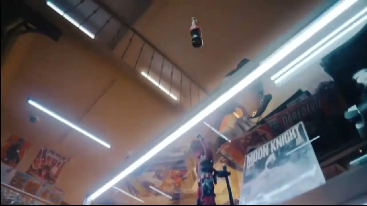 A Coca-Cola bottle flies through the air in a comic book store, with various Marvel characters in the foreground and background.