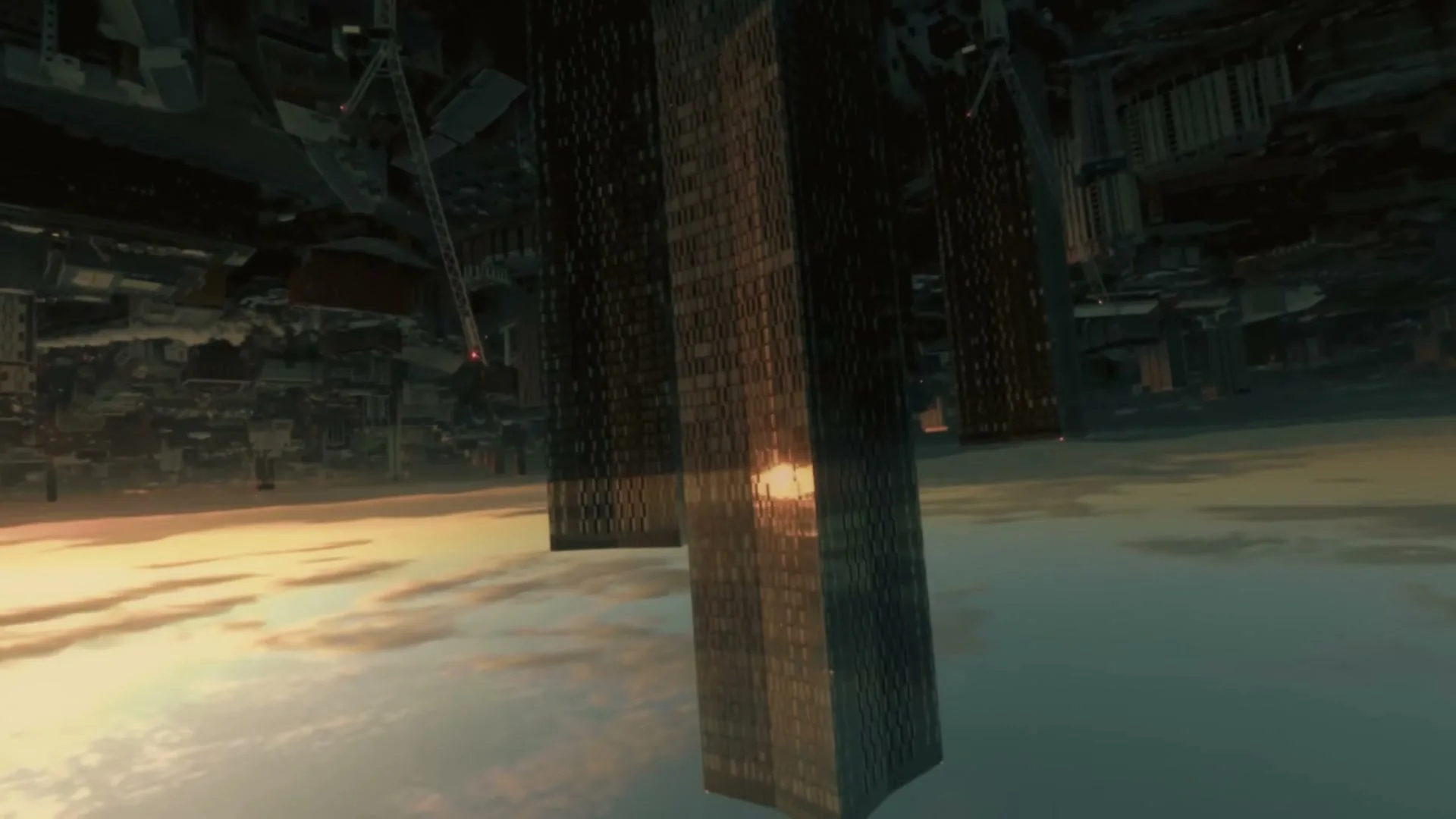 A surreal, inverted cityscape with towering skyscrapers appears to float above a cloudy sky, reflecting the golden light of the setting sun.