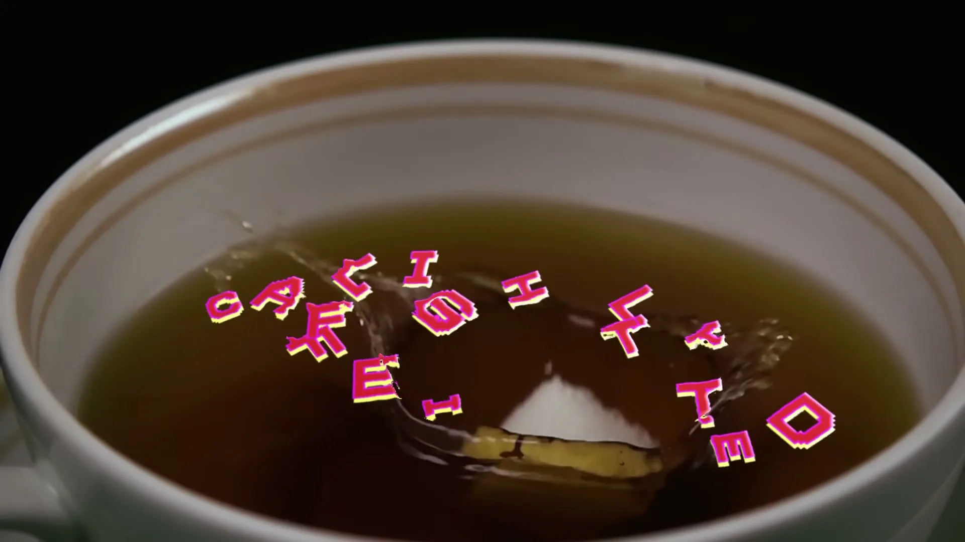 A sugar cube drops into a teacup, causing pixelated text that reads "LIGHTLY CAFFEINATED" to break apart and splash in the tea.