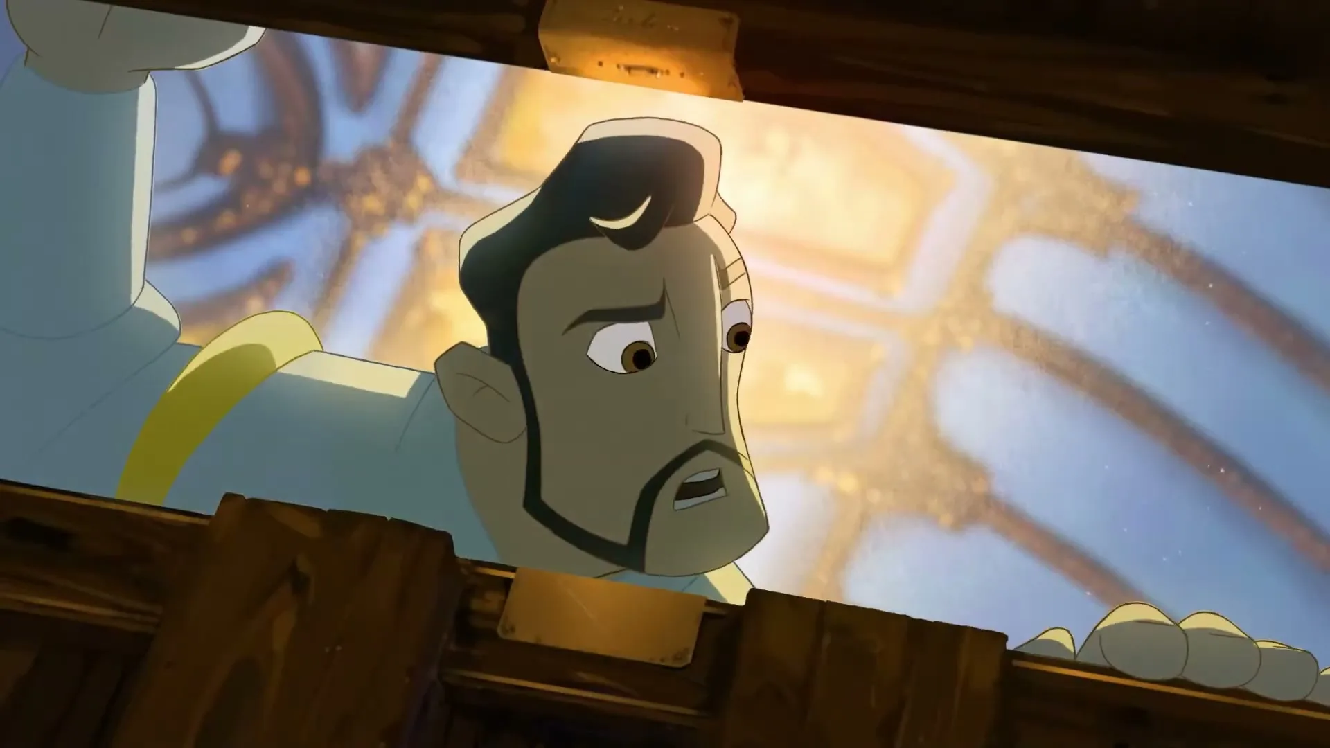 An animated prince, with dark hair and a beard, looks up with a worried expression from behind a wooden railing in a brightly lit, ornate castle interior.