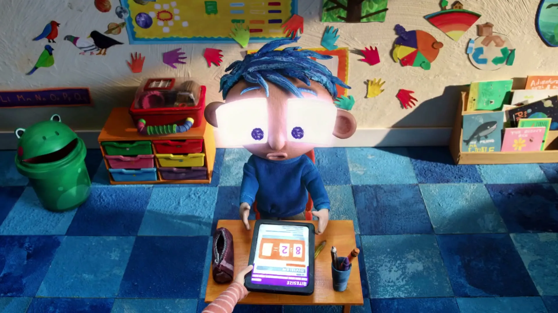 A claymation boy with blue hair sits at a desk in a classroom, looking at a tablet that shows math problems, as his eyes glow with numbers.