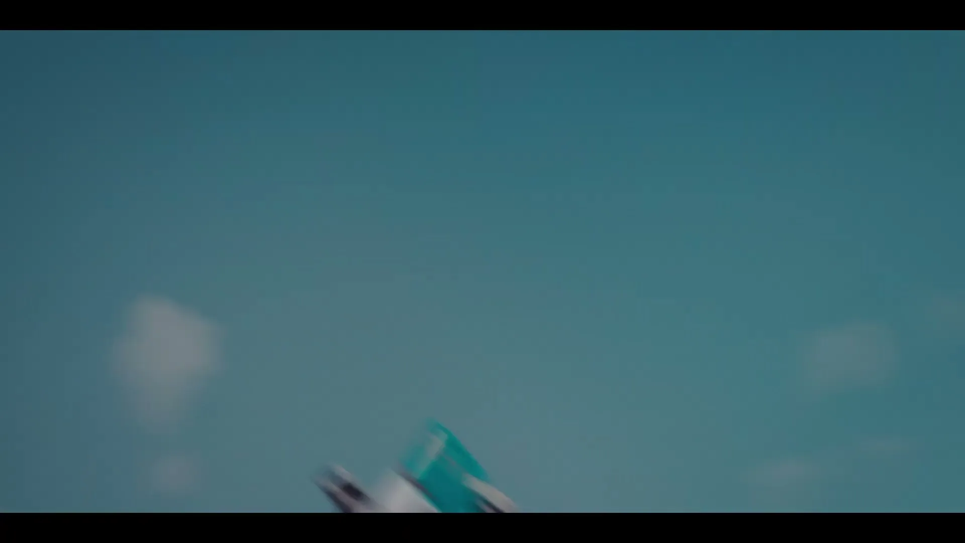 A Formula E race car flips through the air against a blue sky, then falls towards a vast, dark landscape.