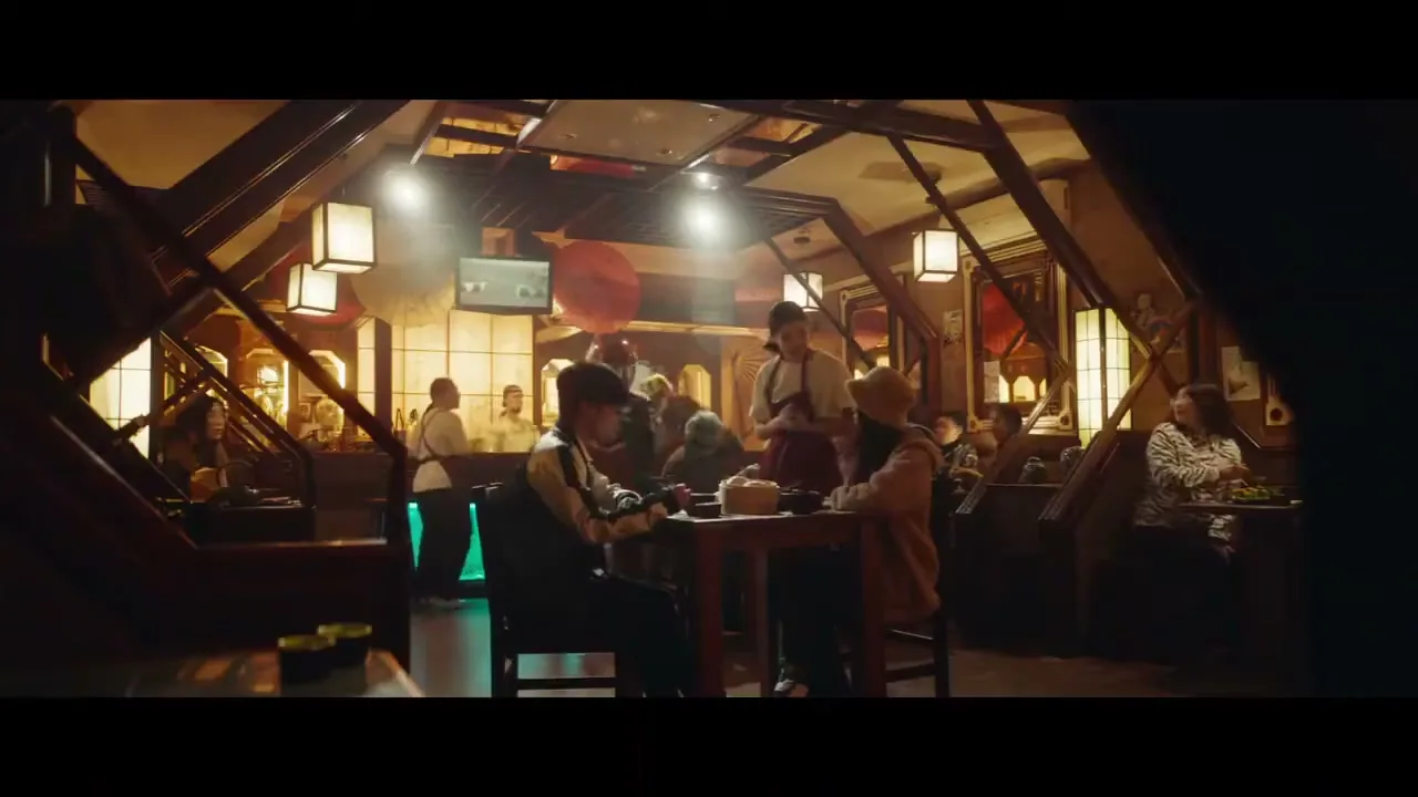 A person in a superhero suit jumps over a table in a busy, dimly lit restaurant, surprising diners.