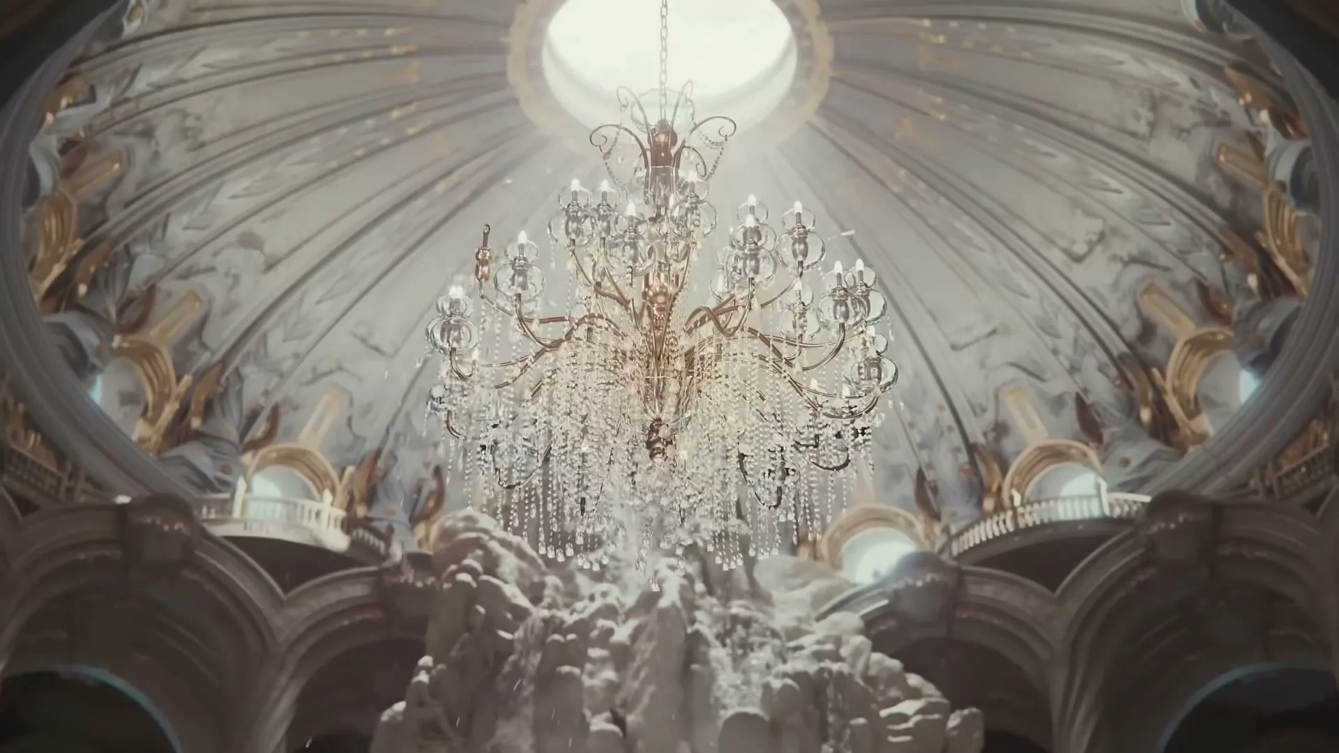 A grand crystal chandelier hangs from a domed ceiling with ornate gold and white decorations, as water splashes below.
