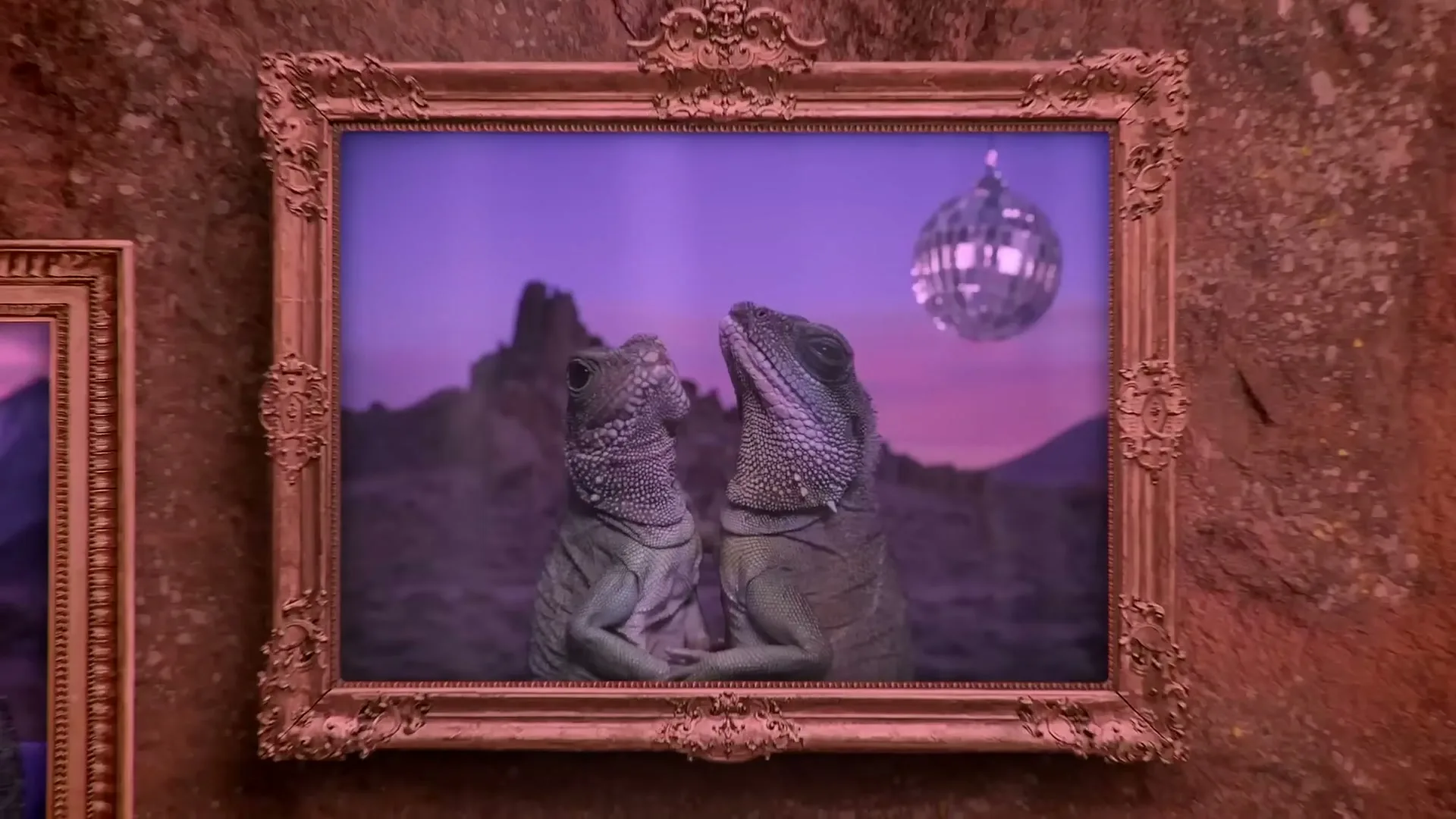 Two lizards are depicted in a framed painting, looking up at a disco ball in a desert landscape under a purple sky.