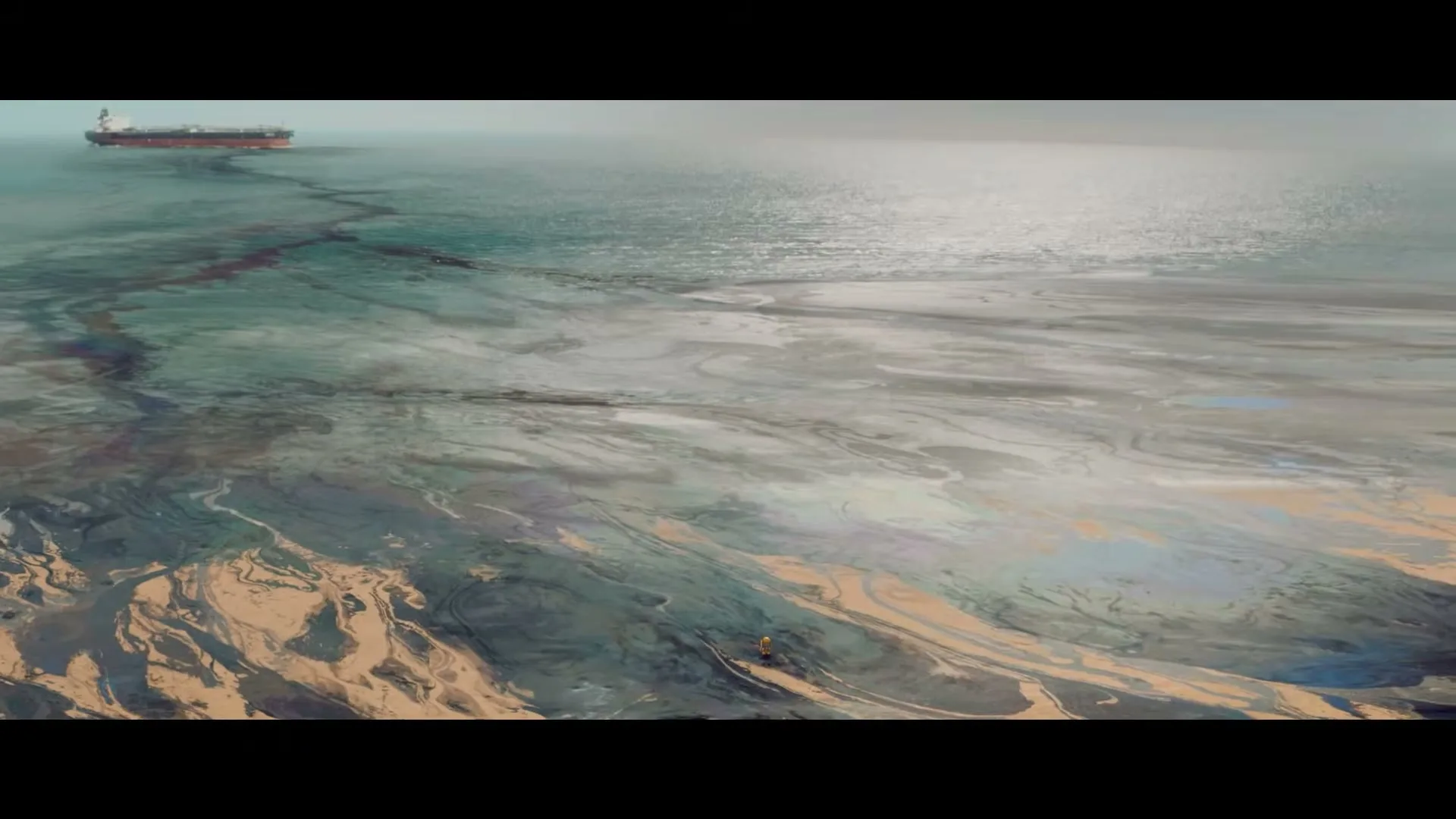 A small yellow robot walks along a polluted shoreline, with a large oil tanker visible in the distance on the ocean.