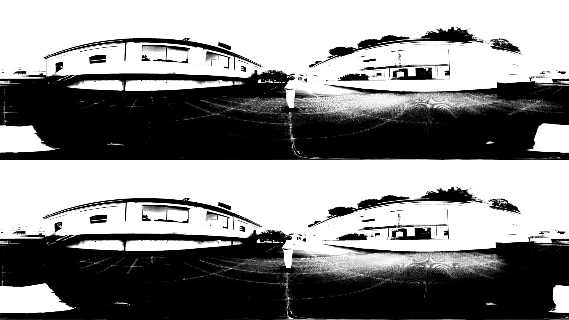 A person in a white outfit walks away from the camera on a black and white street with distorted buildings on either side.