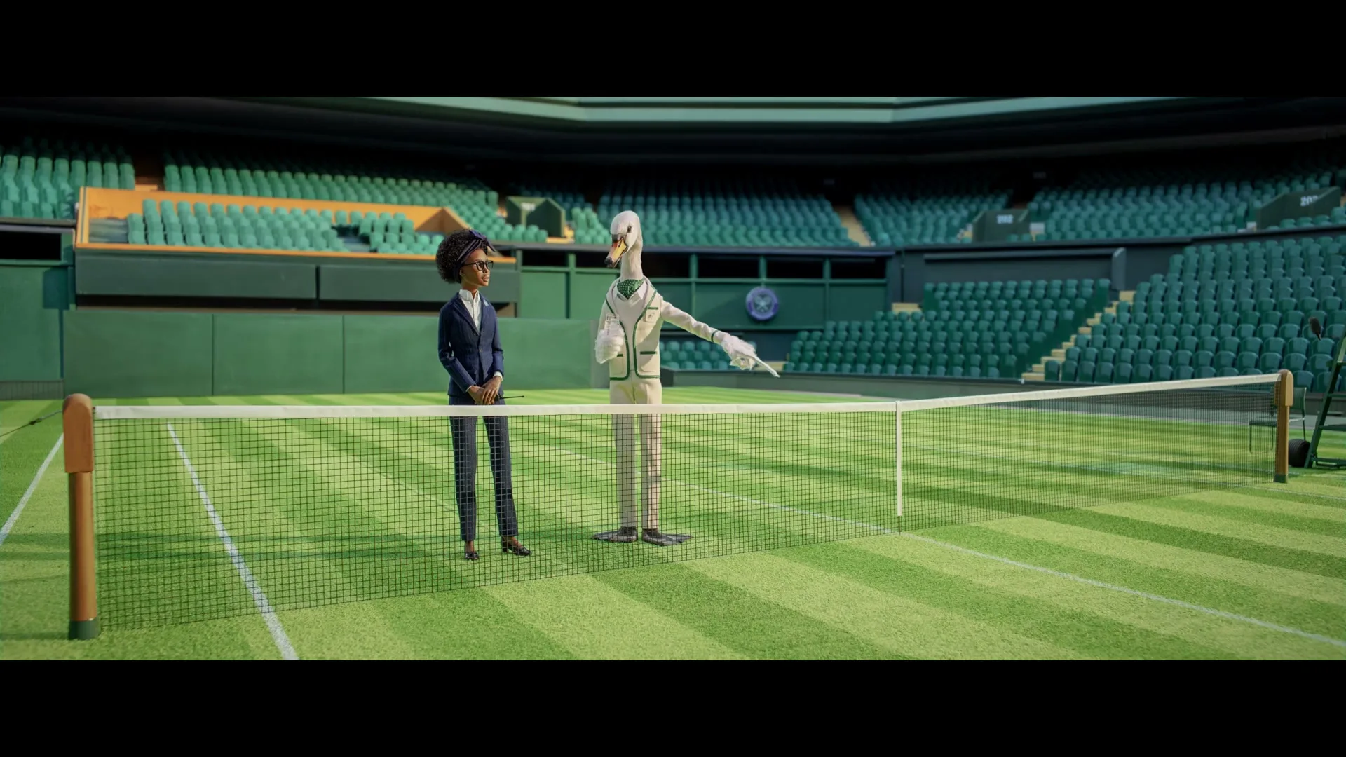A female official in a suit stands next to a swan-like character in a tennis outfit on a tennis court in a large stadium.