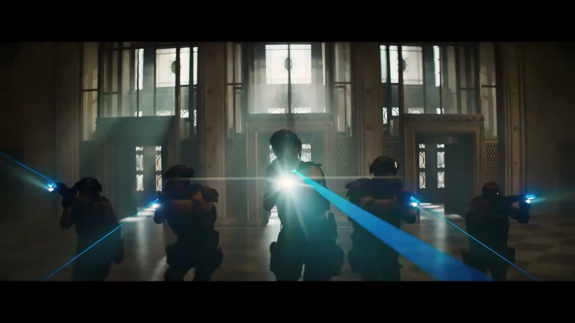Five armed soldiers in tactical gear with glowing blue laser sights on their weapons stand in a large, ornate hall.