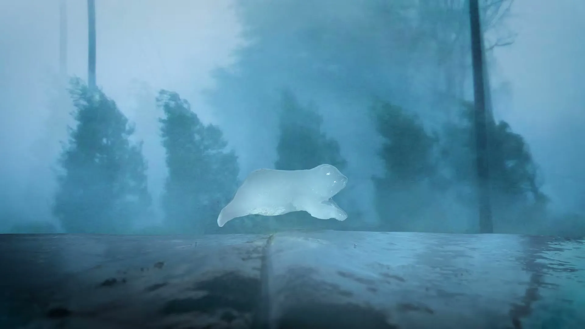 A translucent ice sculpture of a polar bear melts on a dark surface, with blurred trees and a misty blue background.