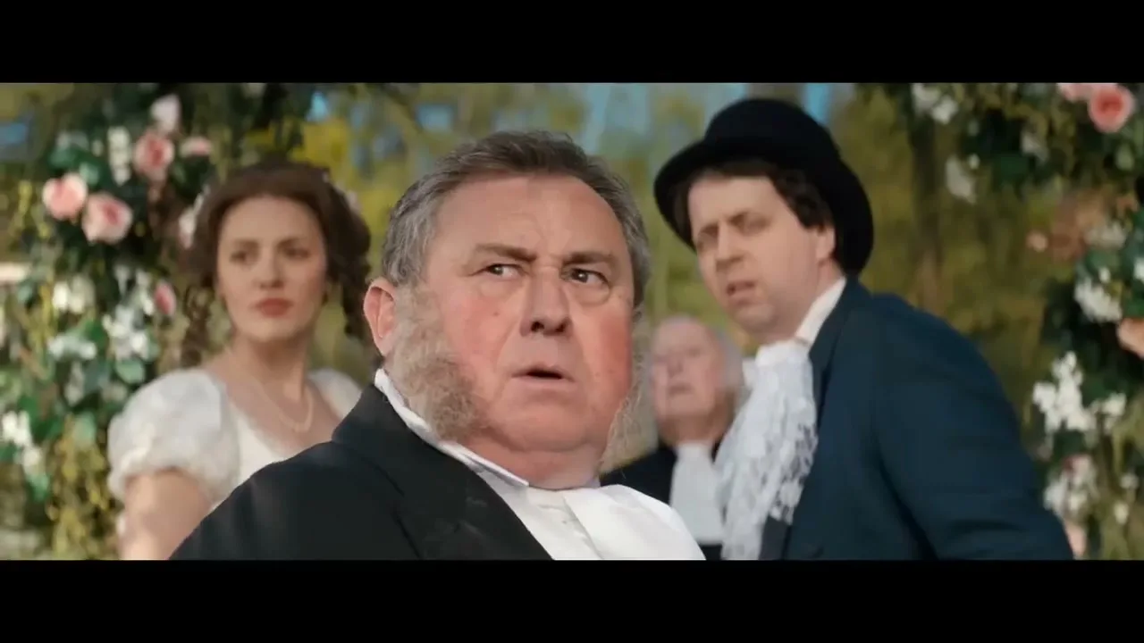 A portly man with sideburns and a white cravat looks surprised, while a woman and another man in period costume look on in a garden setting.