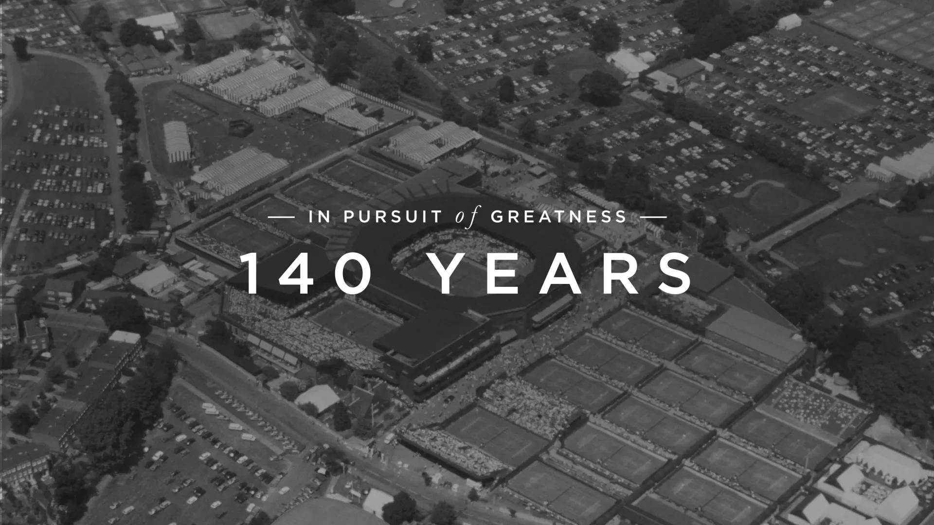 An aerial shot of the Wimbledon tennis grounds, with text overlay "IN PURSUIT of GREATNESS" and "140 YEARS" in black and white.