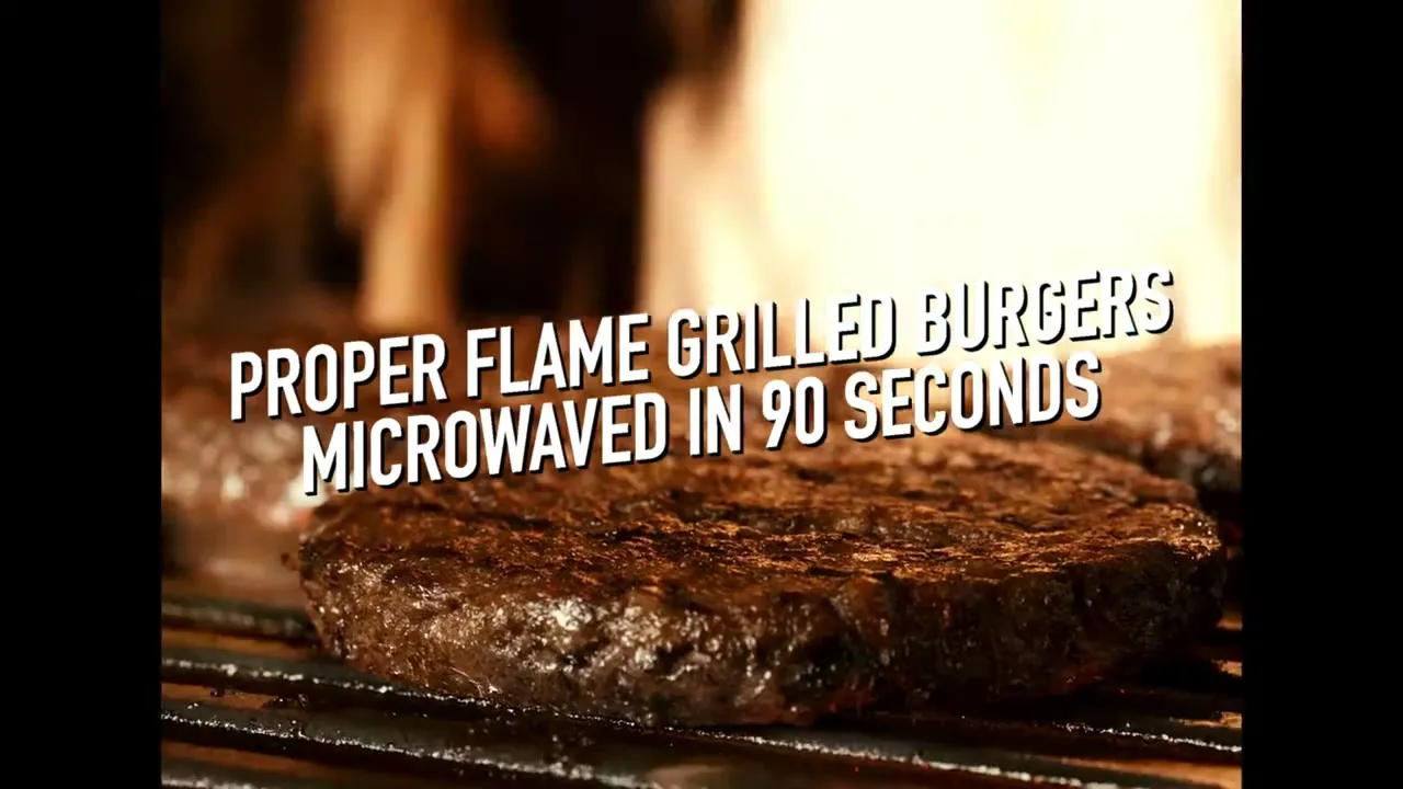 A close-up shot of flame-grilled burgers on a grill, with text overlaying the image, emphasizing their quick microwave preparation.