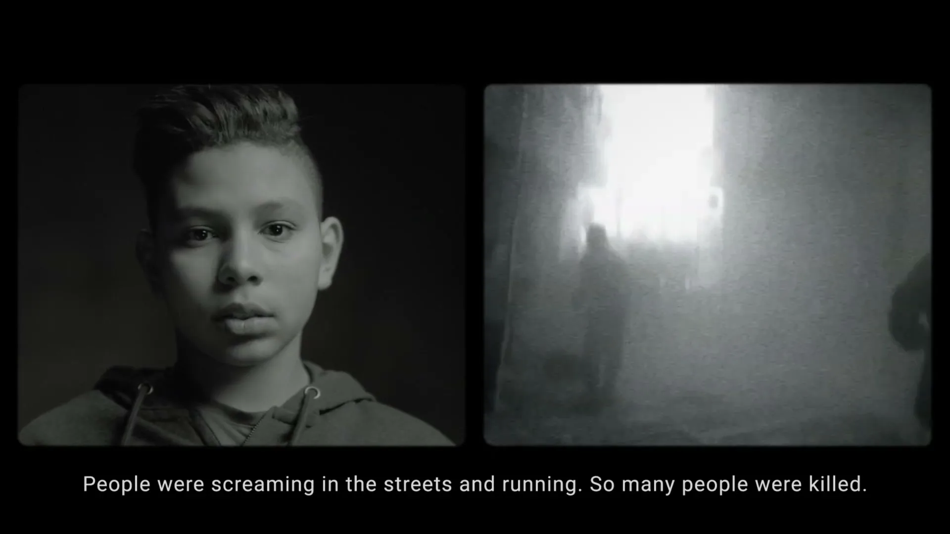 A young boy with a fade haircut speaks to the camera, while a grainy black and white video of people running through a smoky street plays next to him.
