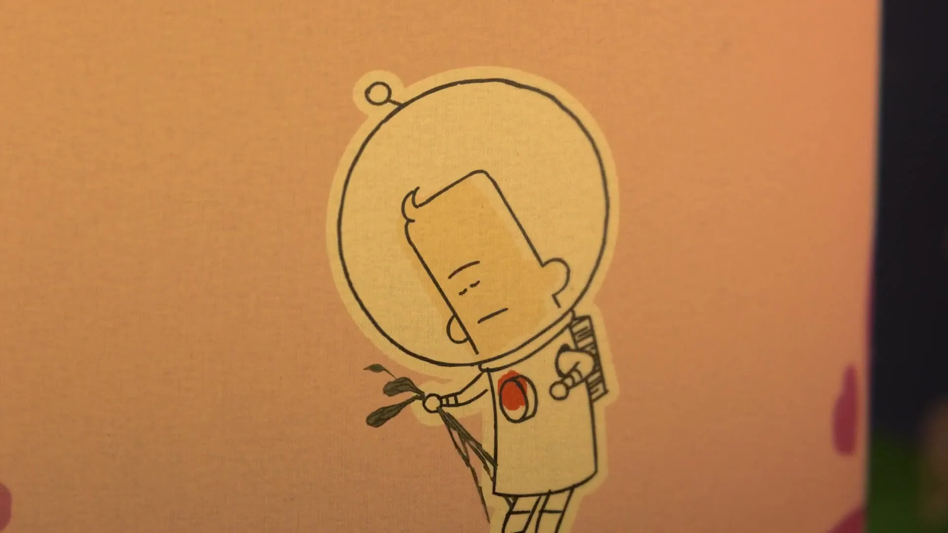 A cartoon astronaut sticker on a pink background looks down sadly, then looks up with a neutral expression.