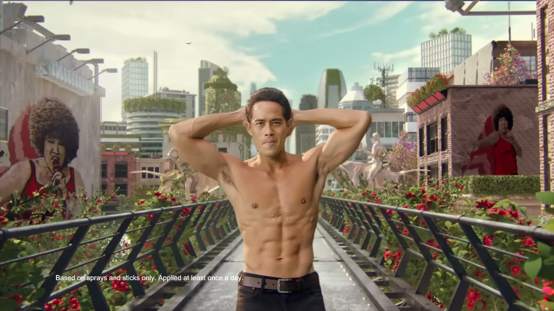 A shirtless man with dark hair poses on a bridge in a futuristic city, with two large murals of a woman on either side.